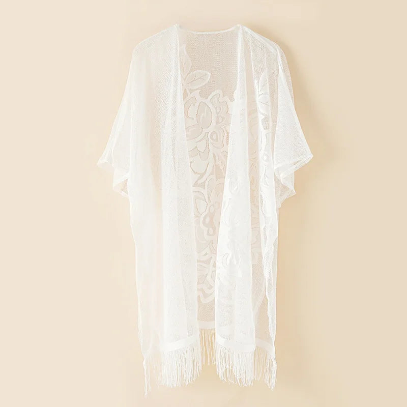 Une blouse pour femme avec un long cardigan en dentelle soluble dans l'eau, un chemisier bikini de protection solaire sur la plage.